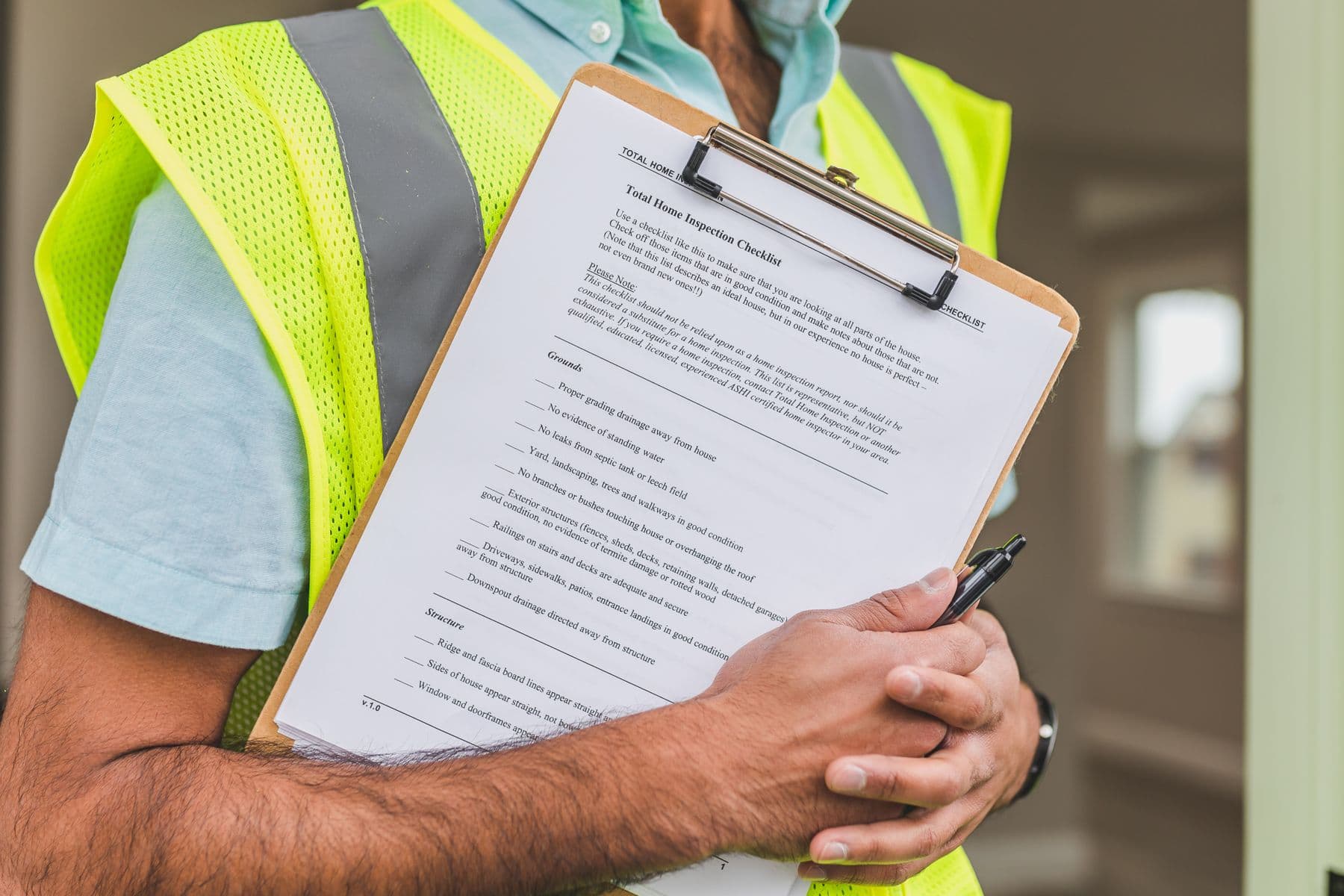 A property inspector holding a home inspection checklist