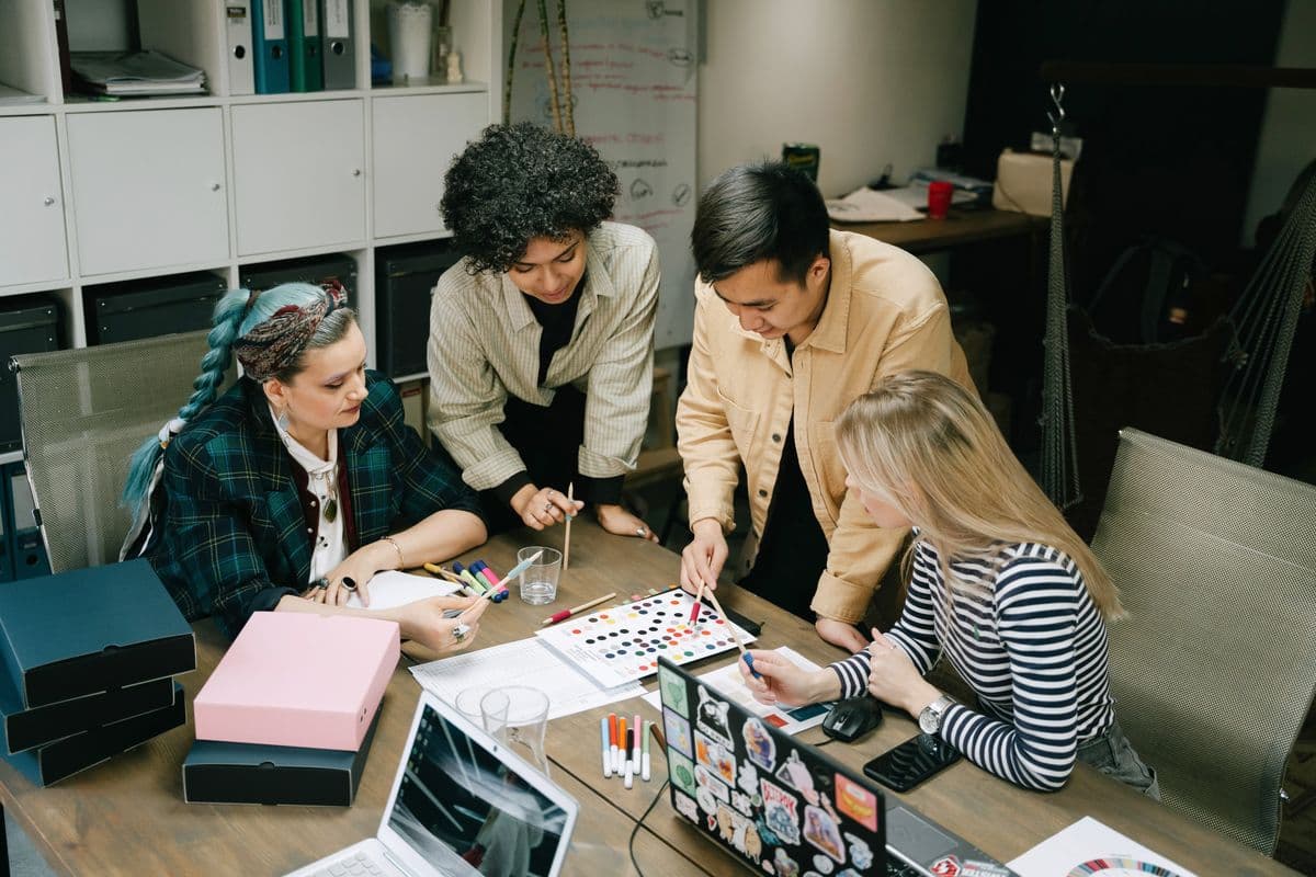 Colleagues coordinating a project around a work table