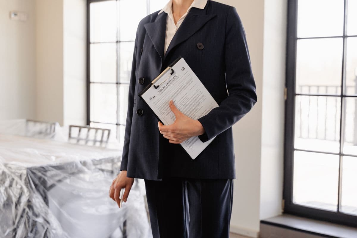 A property professional holding a folder of documents